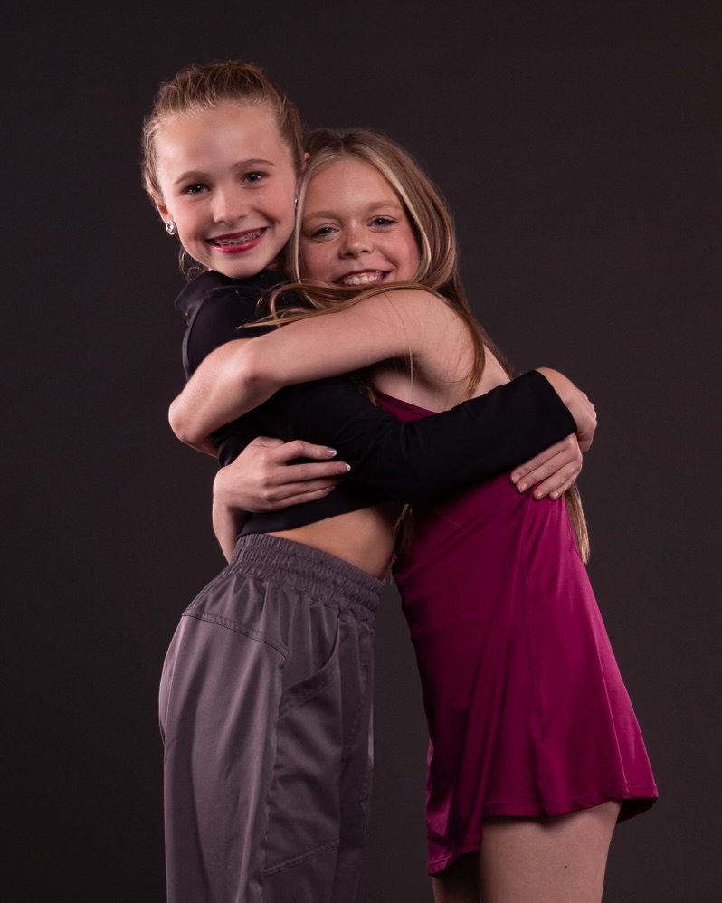 Two young SDI dancers embracing